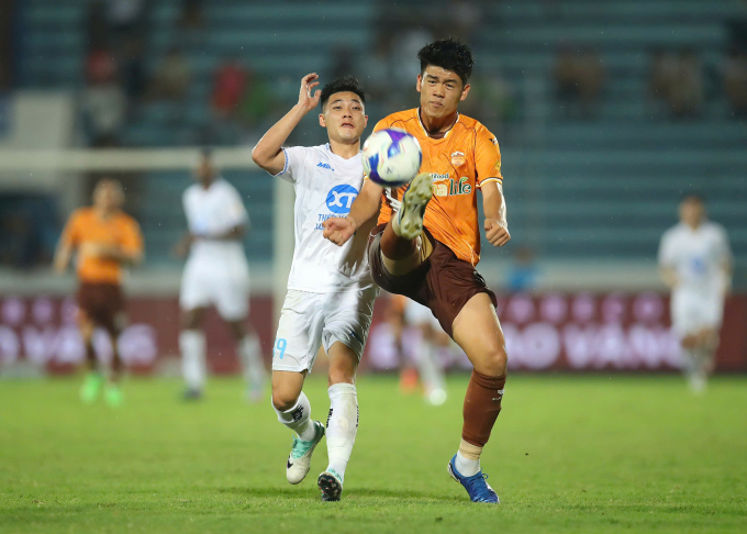 Trung vệ sinh năm 2007 Đinh Quang Kiệt (áo vàng) phá bóng trong trận HAGL thua Nam Định 1-6 ở vòng 23 V-League 2024-2025, trên sân Thiên Trường, Nam Định ngày 18/5/2025. Ảnh: Quang Đương